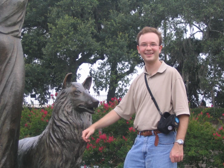 man wearing camera next to statue of a dog