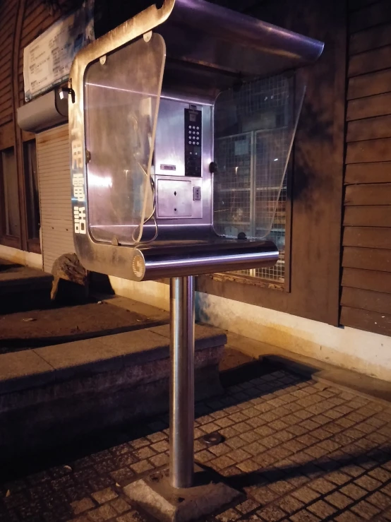 a mailbox on a sidewalk with its door opened