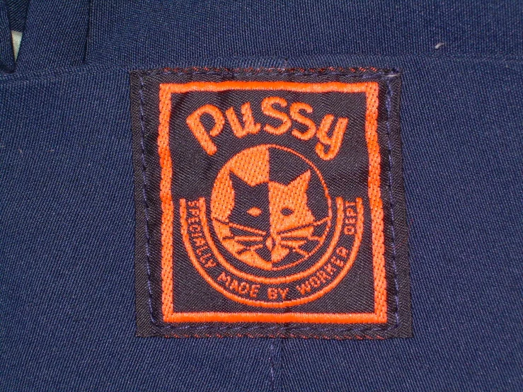 closeup of an orange patch on the back of blue jeans