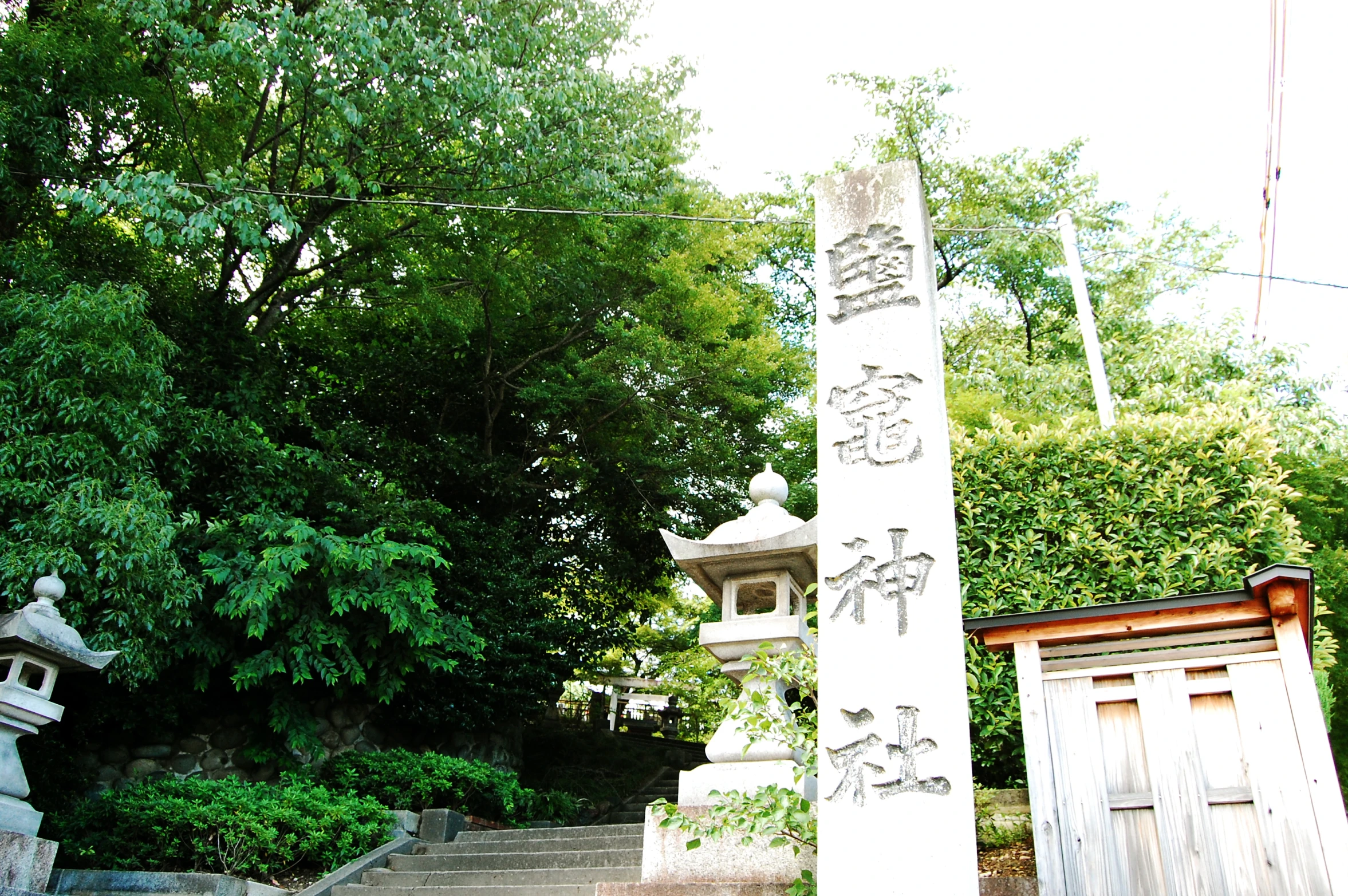 an ornate stone pillar sitting on the side of a wooden walkway