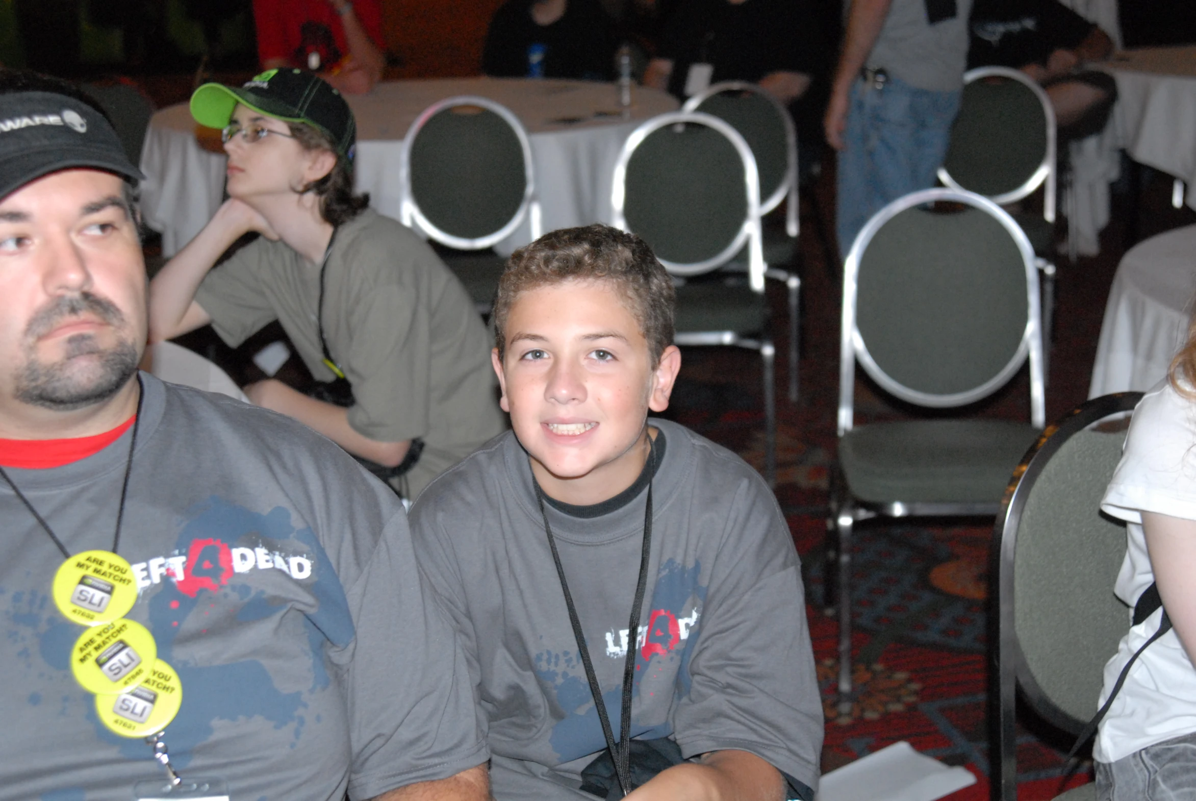 two boys sitting next to each other with their name tags