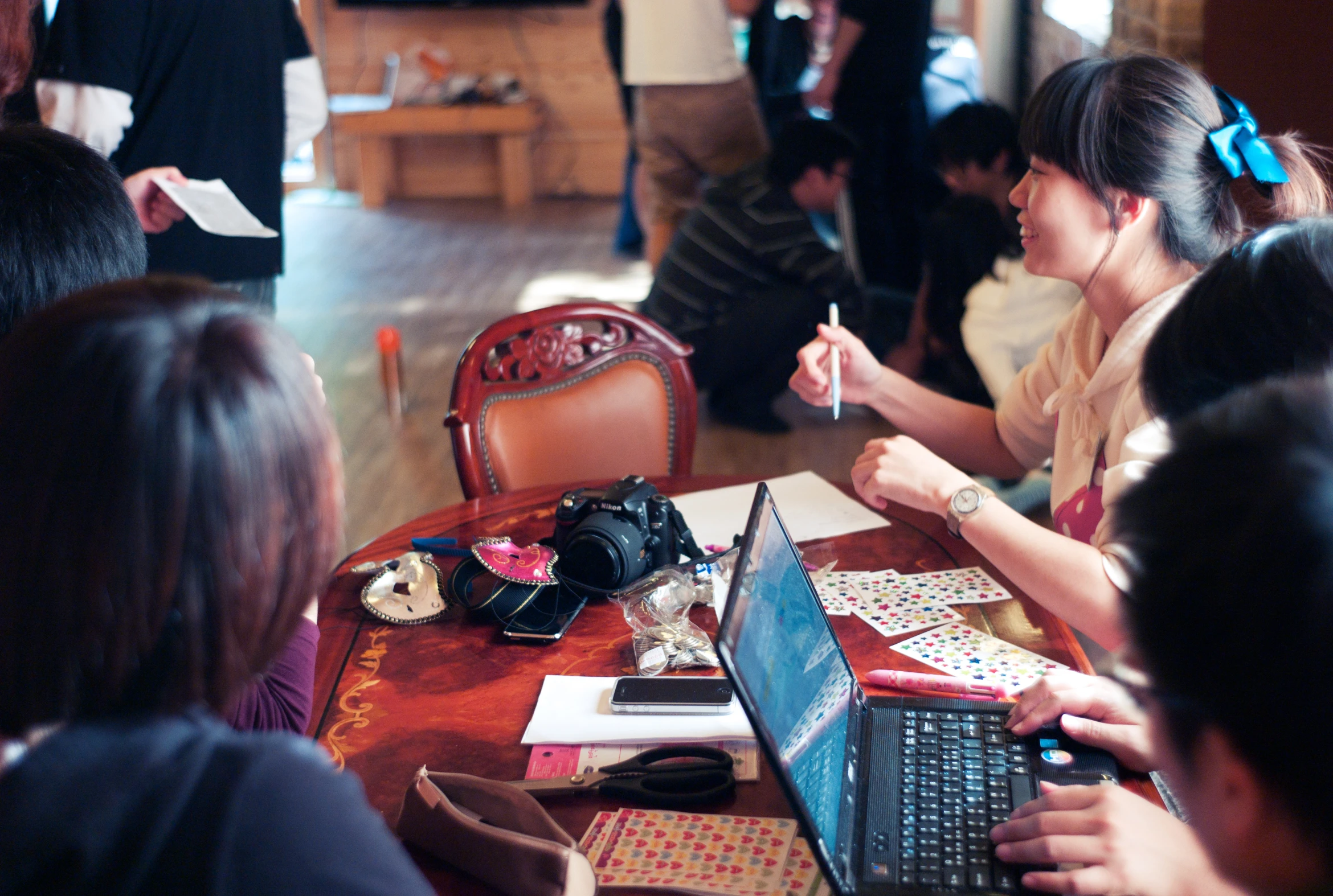 a group of women sitting at a table with laptops