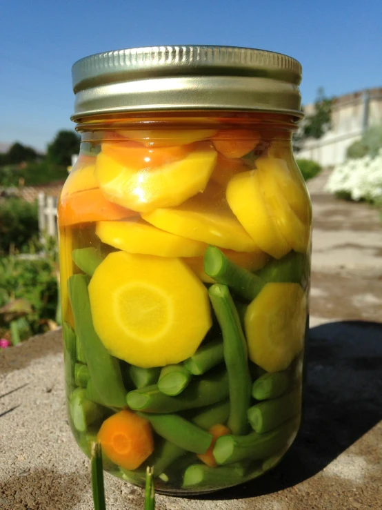 a jar of food sitting on top of a sidewalk