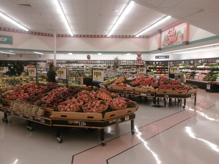 there is a produce section of a store with lots of items