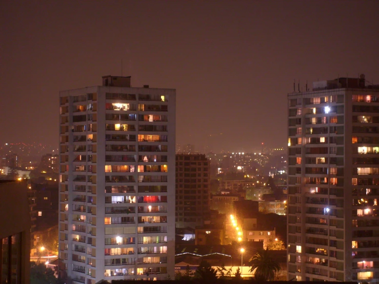 night city lights glowing brightly against tall buildings