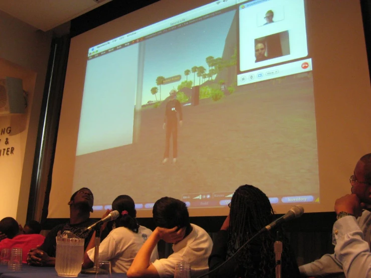 a group of people in front of a projection screen