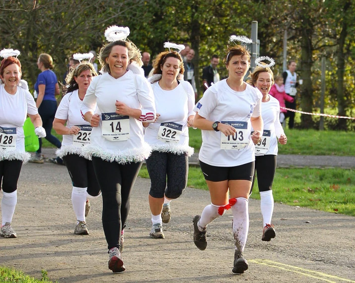 women run in a race wearing costumes