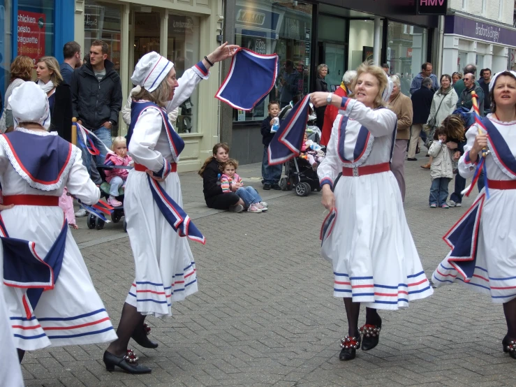 people in a street dancing with a bunch of people