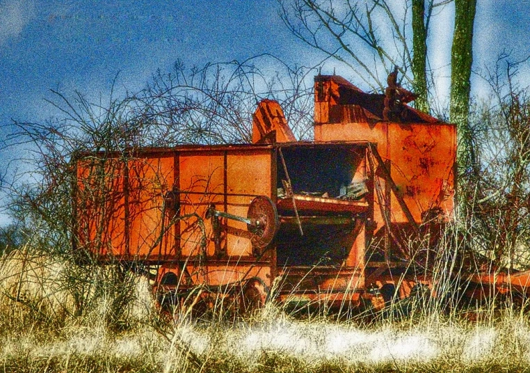 an old abandoned train car sitting in the grass