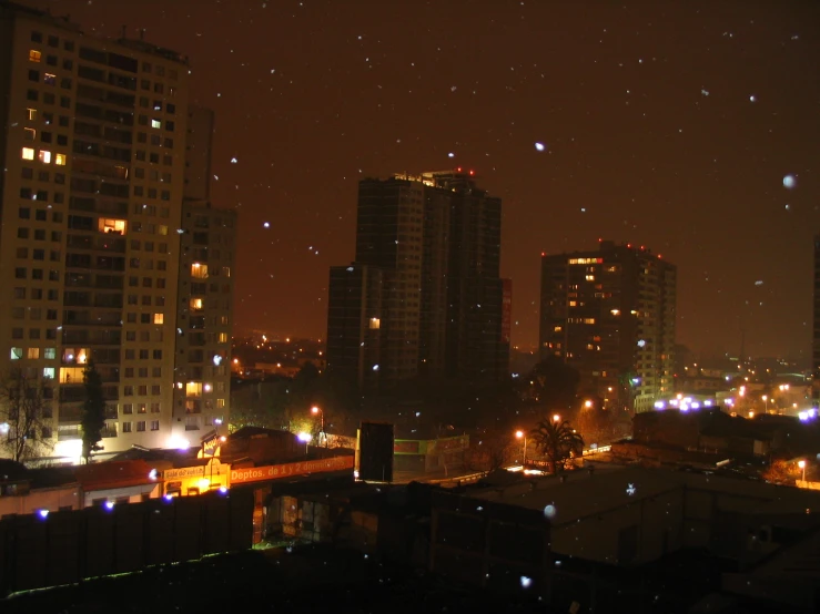 the city at night lit up from behind skyscrs