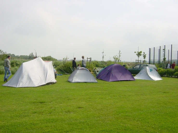 a couple of tents sitting in a green field