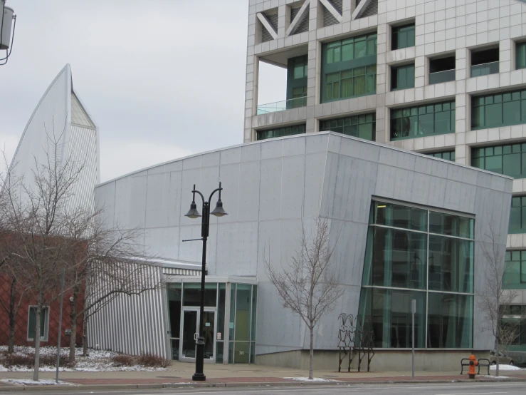 a tall white building with some glass windows