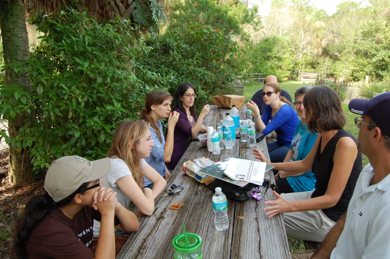 there is a group of people that are sitting around a table