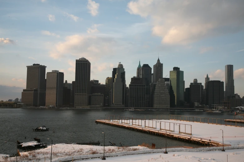 a city is seen across the water with a dock