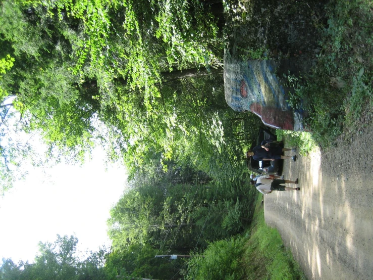 a group of people on a path and some rocks