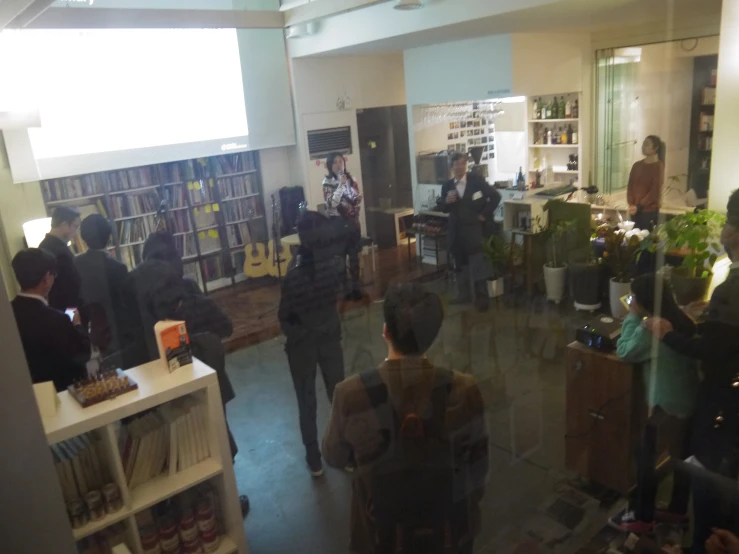 people standing in the room with their book cases