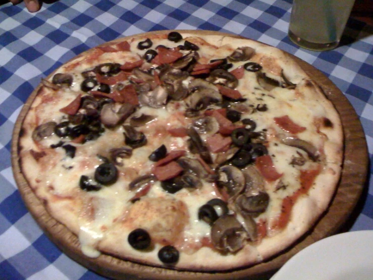 a pizza sitting on top of a table covered in toppings