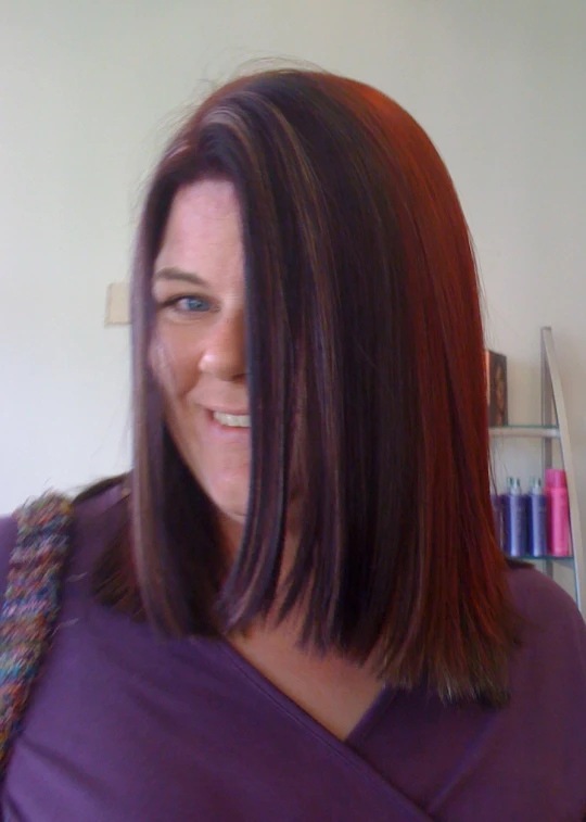 a close up of a woman with brown hair wearing purple