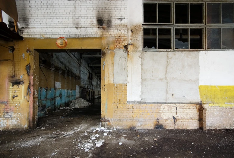 an old run down building with a large open door