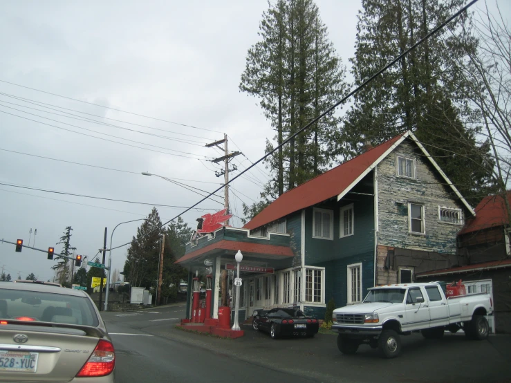 a house sits near a light pole next to a street