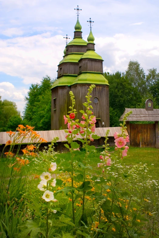 the tall, wooden tower has crosses at the top of it