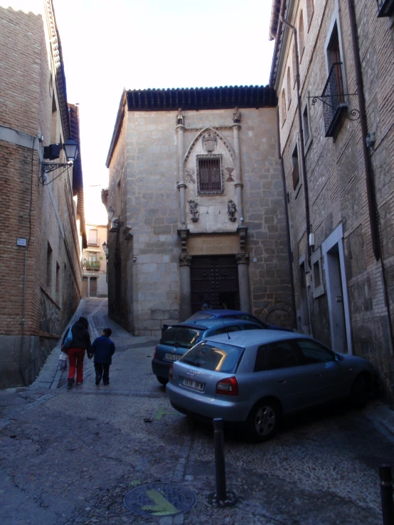 there are people walking down this narrow alley