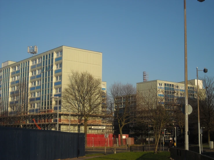 two buildings are behind a fence in the city