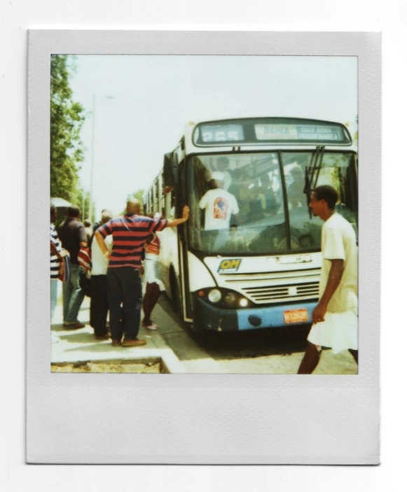 an older man in a striped shirt is getting onto the bus