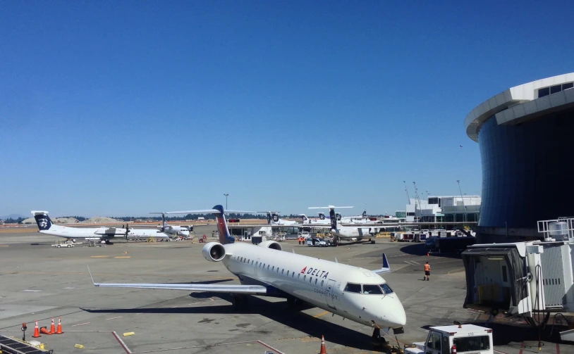 an airplane is parked in an airport under clear skies