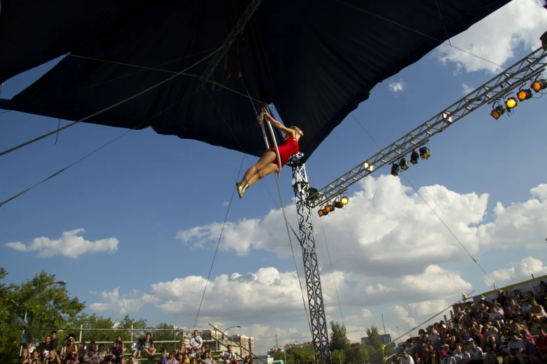 a woman performs aerial stunts on a stage