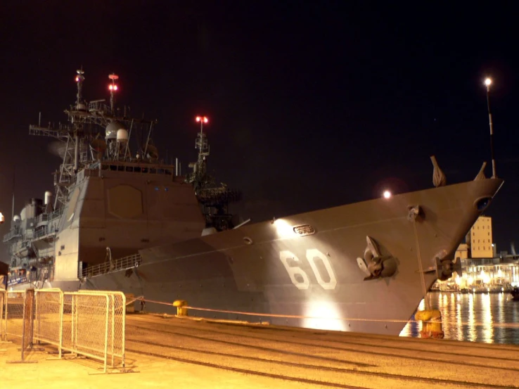 a military boat in a port at night