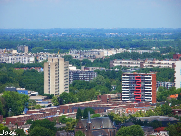 a city filled with tall buildings surrounded by green trees