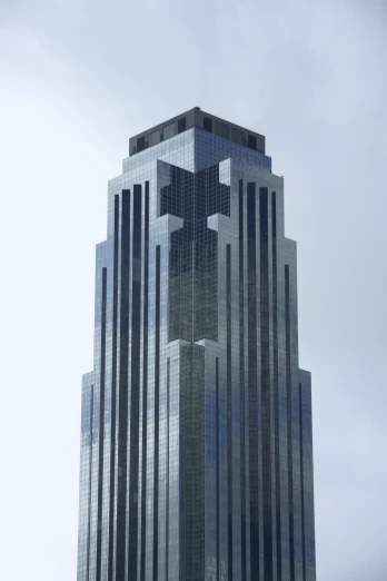 the tall building with the face reflected in the glass is on the corner