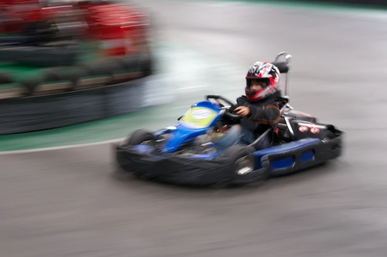 a little boy rides on an go kart