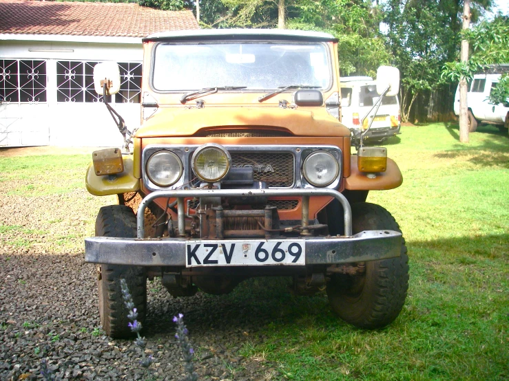 an orange truck parked in front of a house