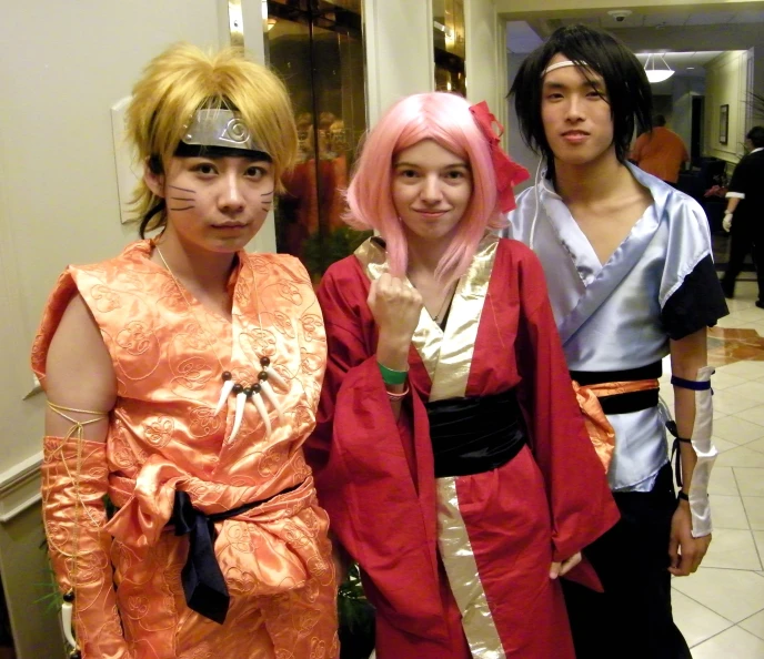 three people are dressed in costumes and standing on a tile floor