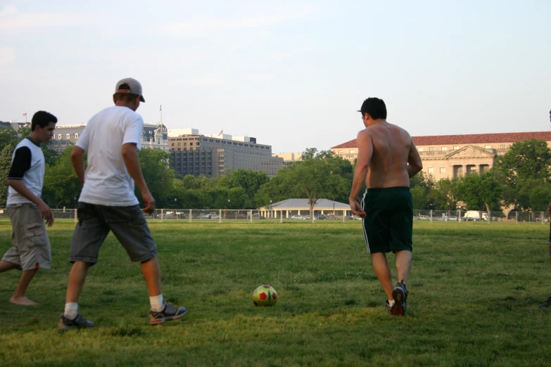 a group of guys running around a soccer field