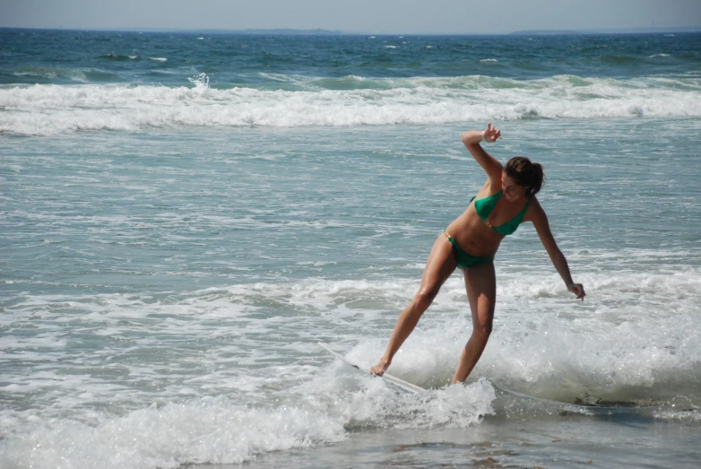 a woman in a bikini surfing on a wave