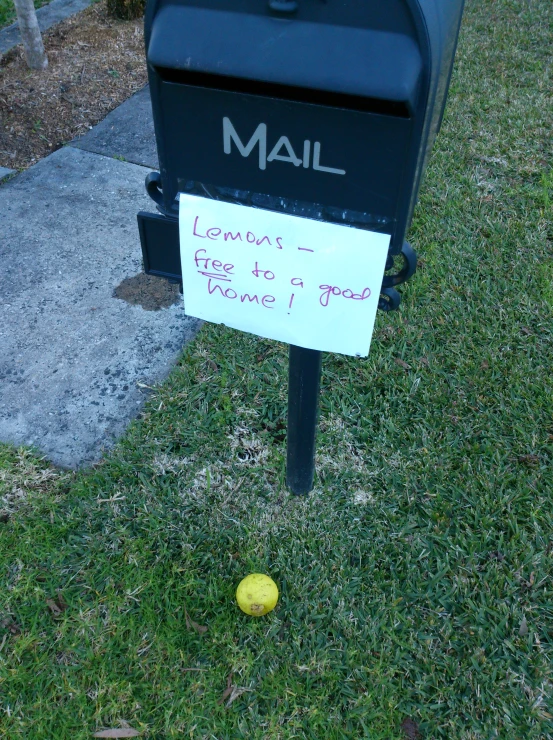 a mailbox sitting on the side of a sidewalk