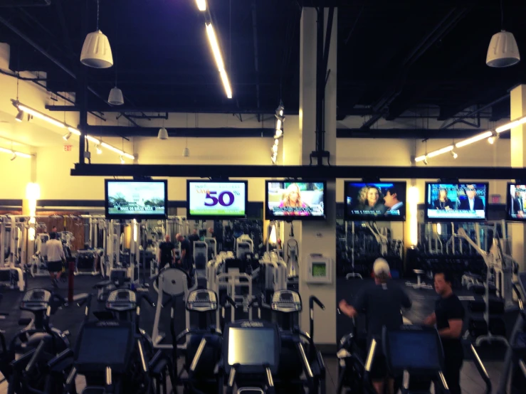 a gym filled with stationary bikes and spinning wheel