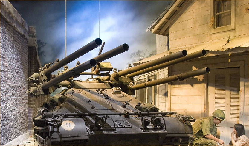 two soldiers observing a tank on display in a museum