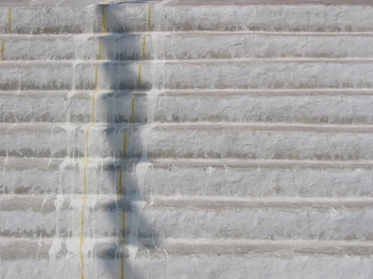 the shadow of a person standing next to steps