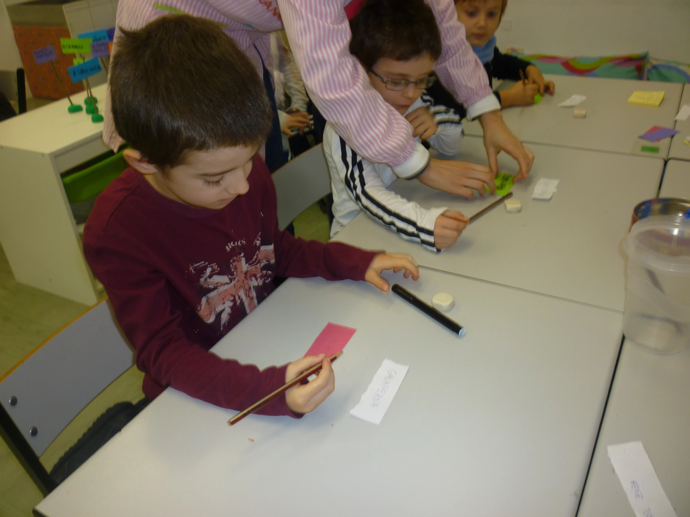 two children playing on the same table and other activity