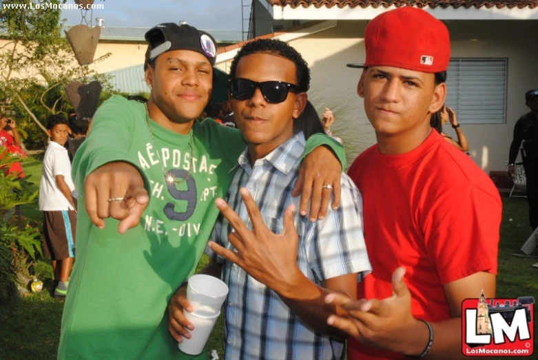 three men at a party posing for a po together