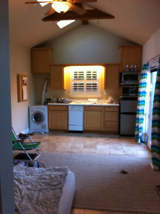 an open floor plan with an electric oven and washing machine