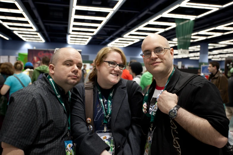 a group of people are posing together with their thumbs up