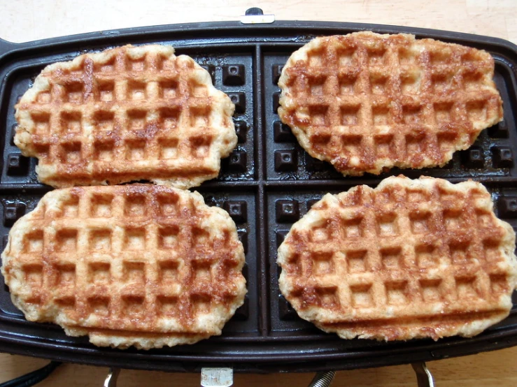 three pieces of fried food sit in a pan