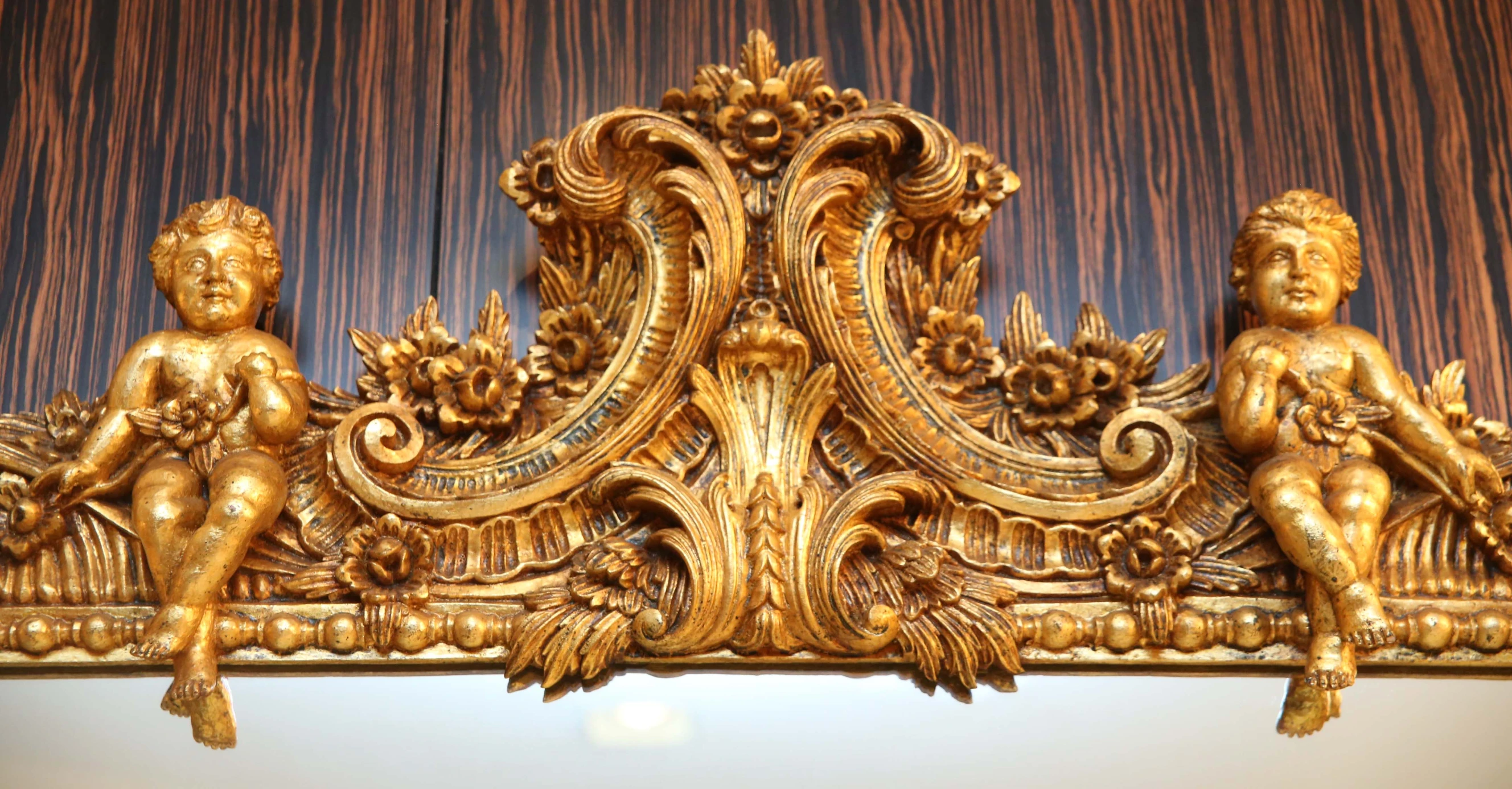 a decorative mirror that has some fancy gold carvings on it