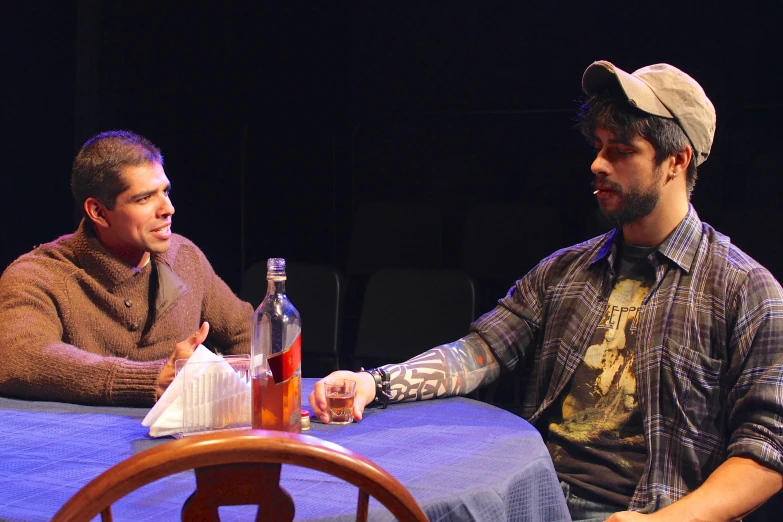 two people sitting around a table at a dinner