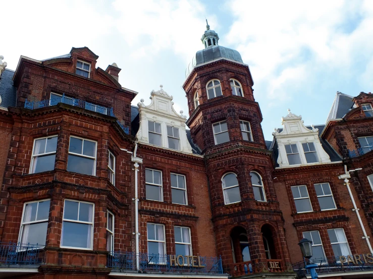 several windows in an old building, with a sky background